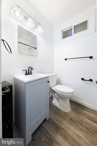 a bathroom with a sink toilet and mirror