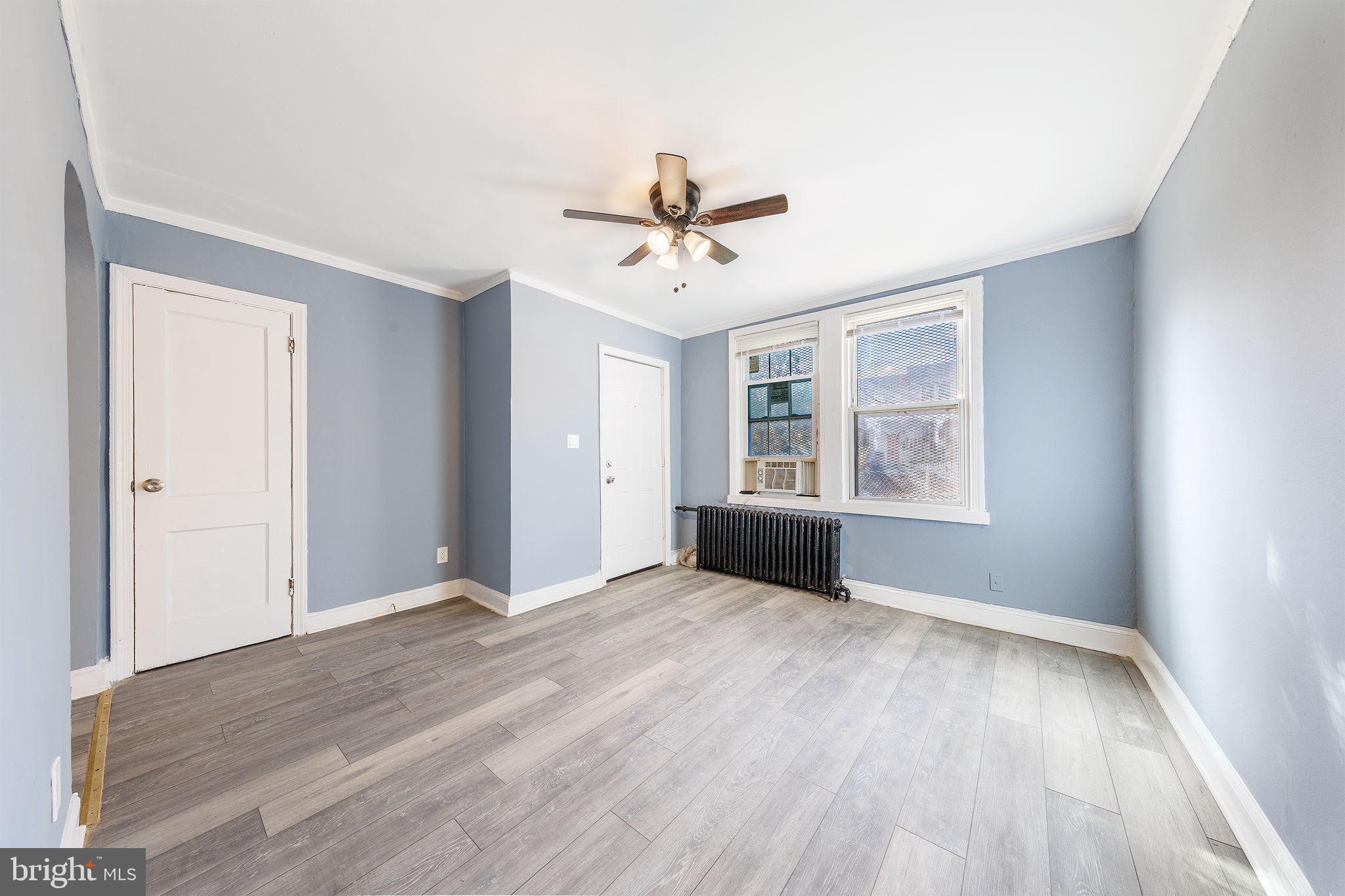 905 19th Street Northeast, Unit 1 Washington, DC 20002 - Photo 9 of 21 an empty room with wooden floor ceiling fan and windows