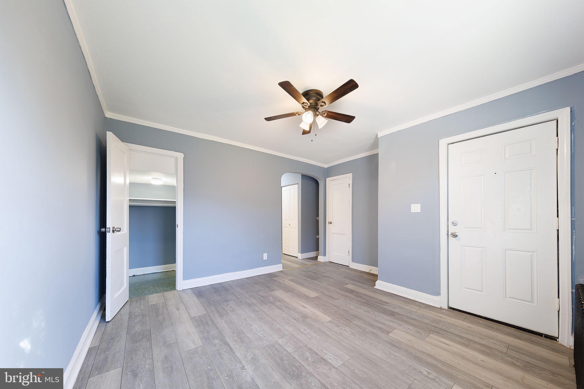 905 19th Street Northeast, Unit 1 Washington, DC 20002 - Photo 10 of 21 a view of a big room with wooden floor and a ceiling fan