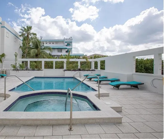 a view of a chairs and table in the backyard