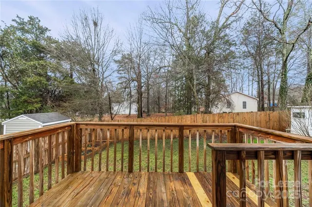 a view of balcony with wooden floor and fence