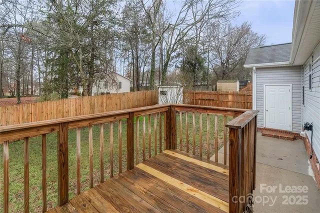 a view of balcony with wooden floor and fence