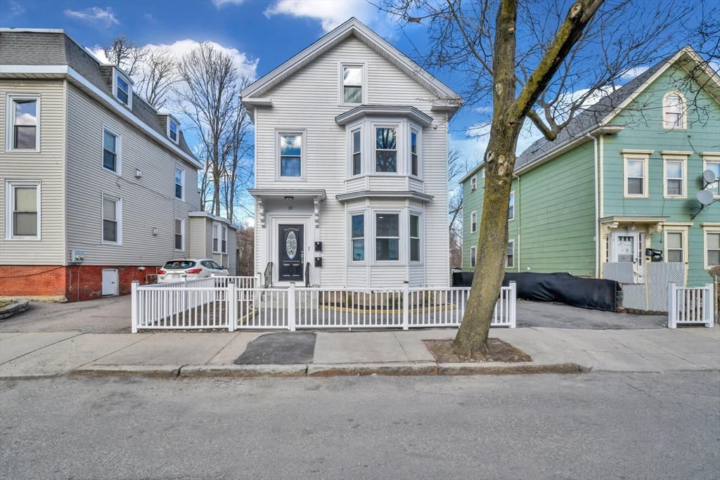 21 Marcella Street, Unit 2 Boston, MA 02119 - Photo 1 of 22 a front view of a house with a yard and garage