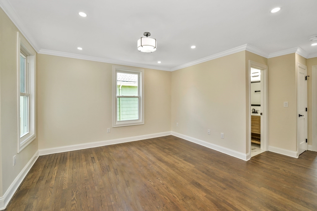 21 Marcella Street, Unit 2 Boston, MA 02119 - Photo 14 of 22 an empty room with wooden floor and windows