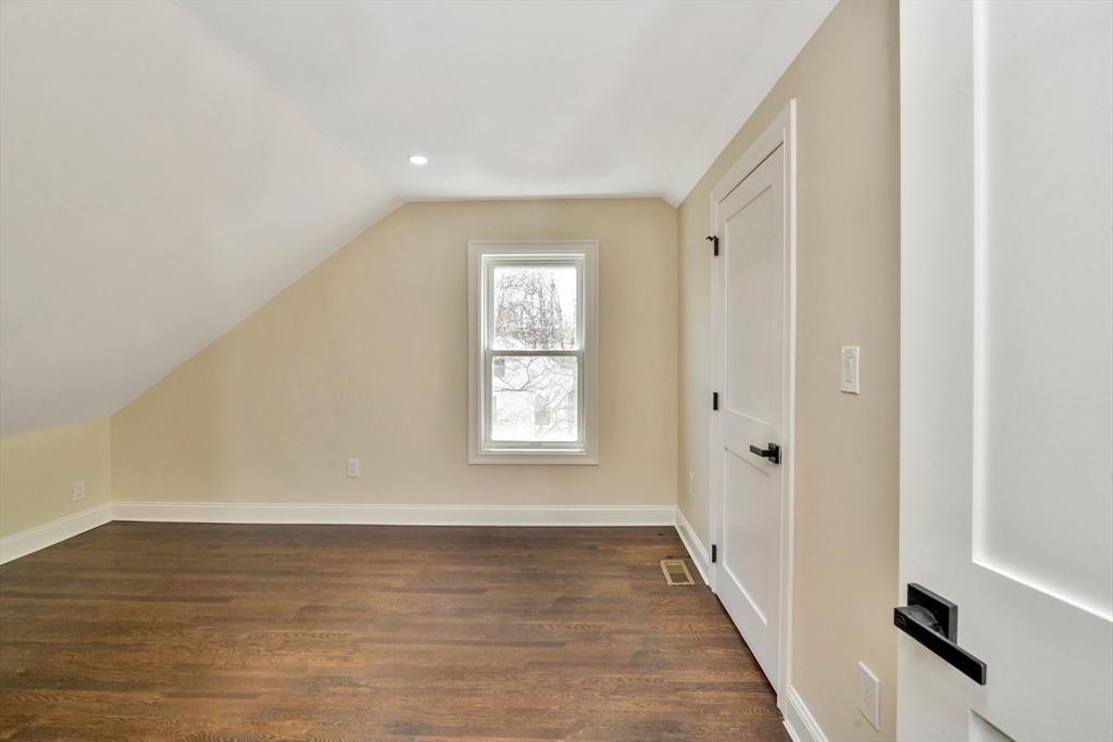 21 Marcella Street, Unit 2 Boston, MA 02119 - Photo 16 of 22 a view of an empty room with wooden floor and a window