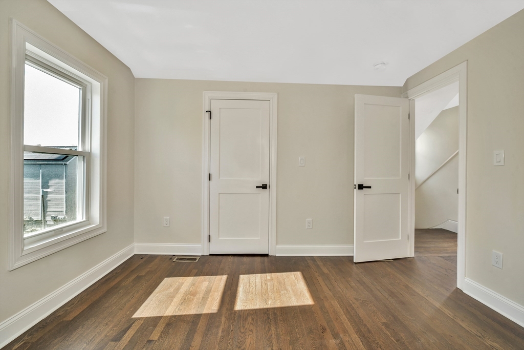 21 Marcella Street, Unit 2 Boston, MA 02119 - Photo 18 of 22 a view of an empty room window and wooden floor