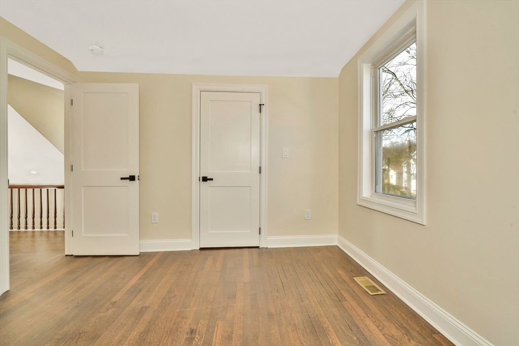 21 Marcella Street, Unit 2 Boston, MA 02119 - Photo 19 of 22 an empty room with wooden floor and windows