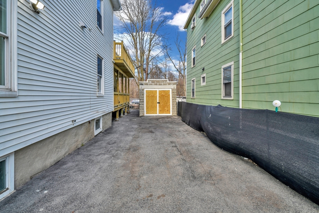 21 Marcella Street, Unit 2 Boston, MA 02119 - Photo 21 of 22 a view of a house with a small yard and wooden fence