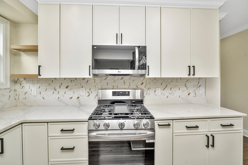 21 Marcella Street, Unit 2 Boston, MA 02119 - Photo 5 of 22 a white stove top oven sitting inside of a kitchen