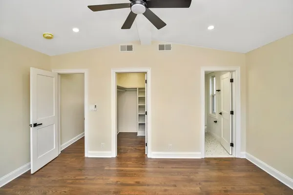a view of empty room with wooden floor