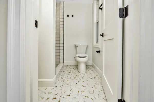 a bathroom with a toilet and a shower