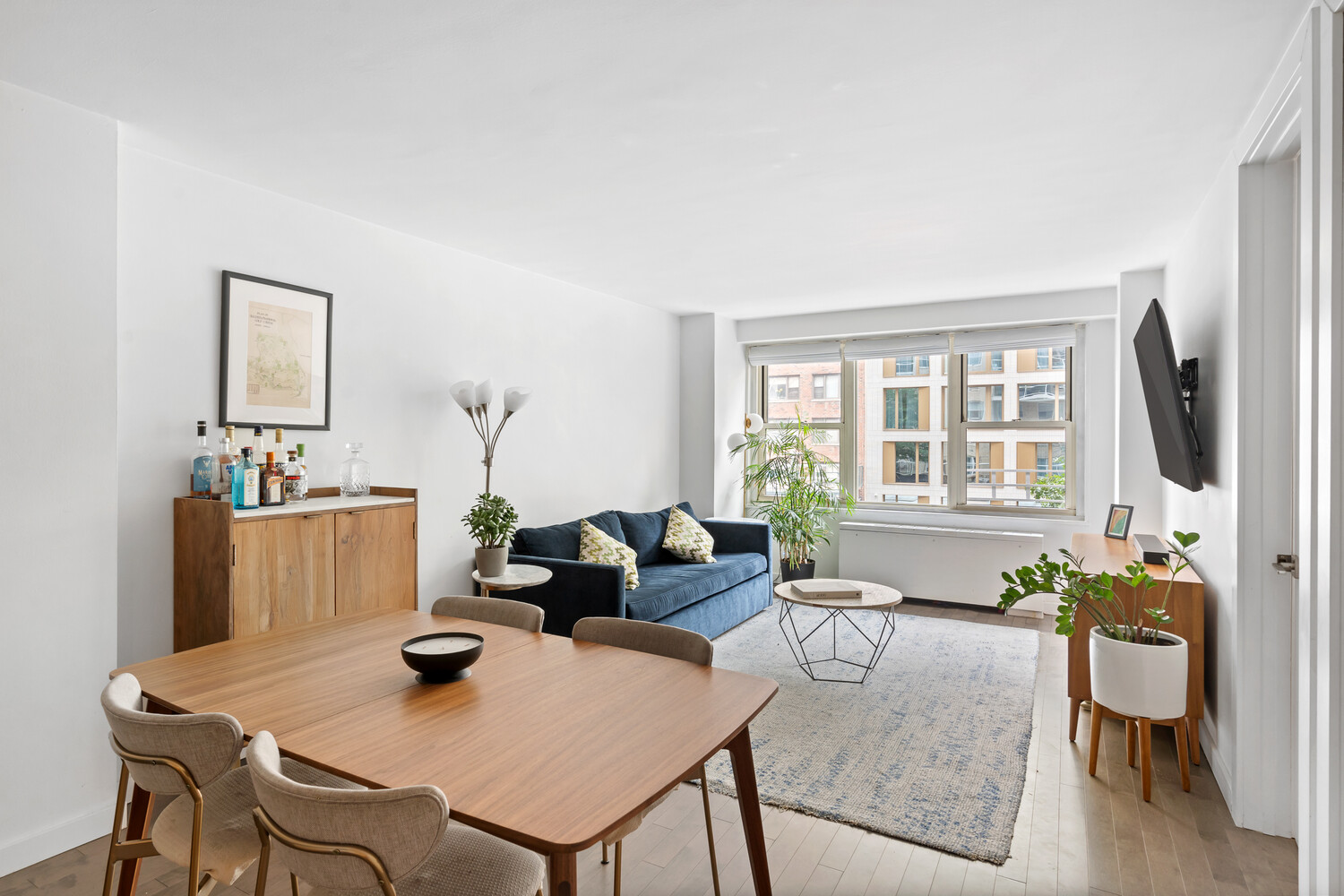 305 East 24th Street, Unit 3B Manhattan, NY 10010 - Photo 1 of 11 a living room with furniture and a window