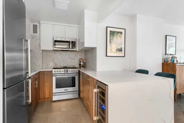 a open kitchen with cabinets a stove and a refrigerator