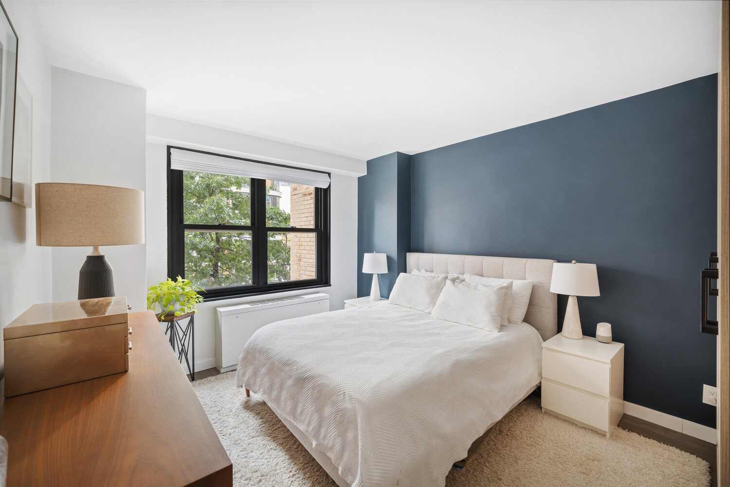 305 East 24th Street, Unit 3B Manhattan, NY 10010 - Photo 7 of 11 a bedroom with a bed and large window