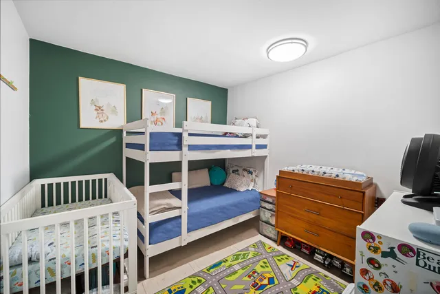 a bedroom with a bed and large window