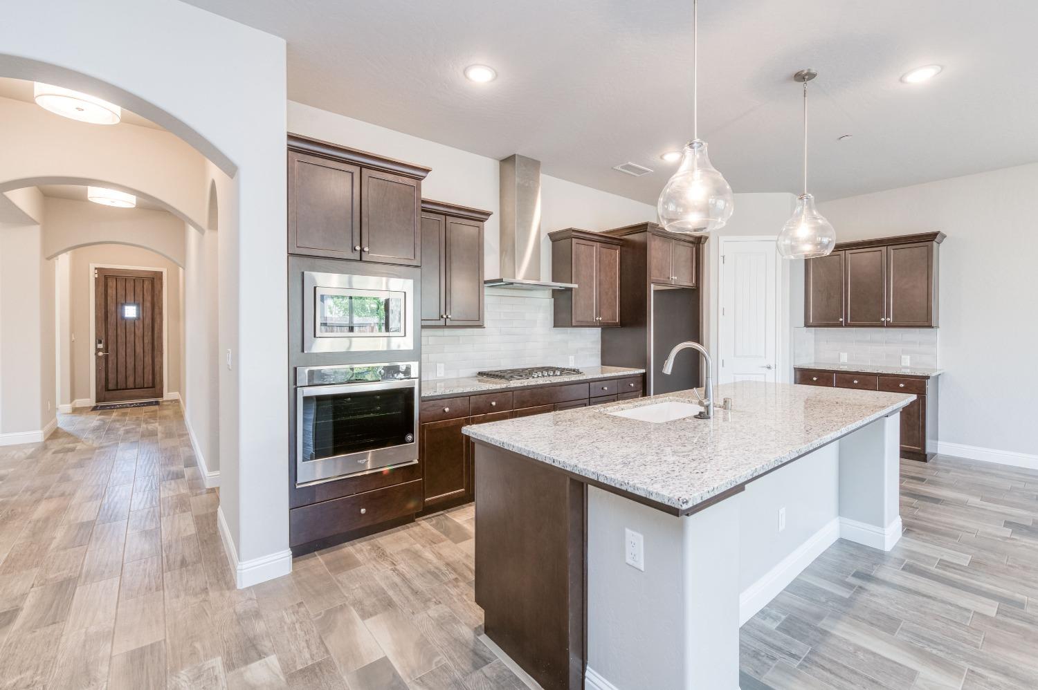 1729 North Carson Avenue Clovis, CA 93619 - Photo 14 of 38 a kitchen with a kitchen island a sink stainless steel appliances and cabinets
