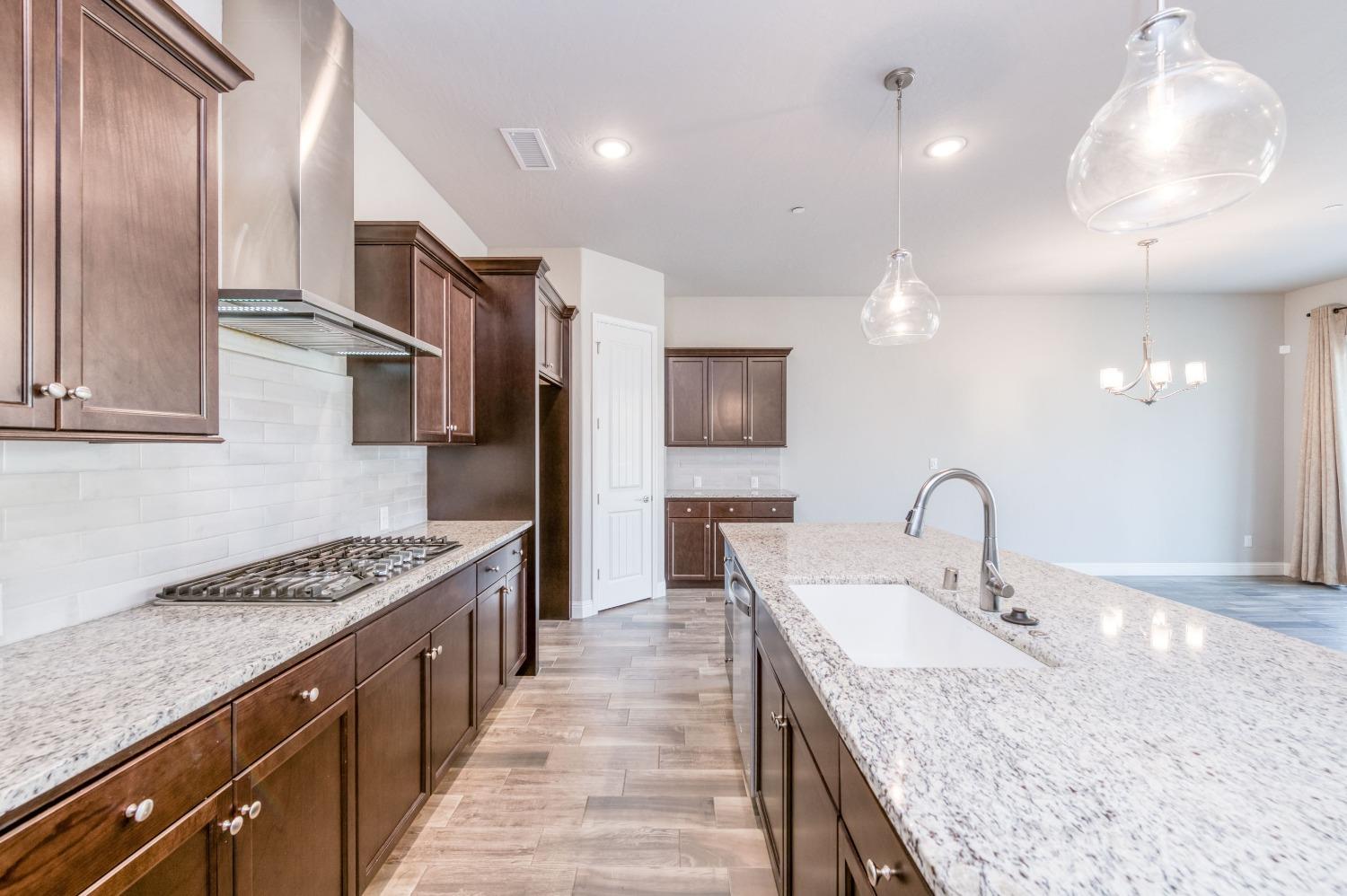 1729 North Carson Avenue Clovis, CA 93619 - Photo 15 of 38 a kitchen with granite countertop a sink and cabinets