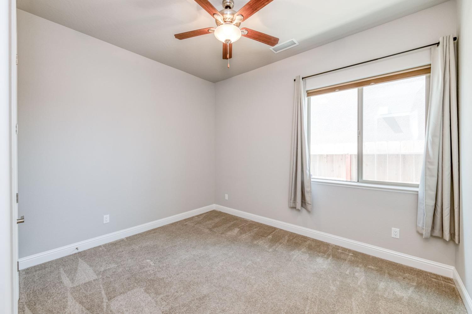 1729 North Carson Avenue Clovis, CA 93619 - Photo 16 of 38 an empty room with windows and fan