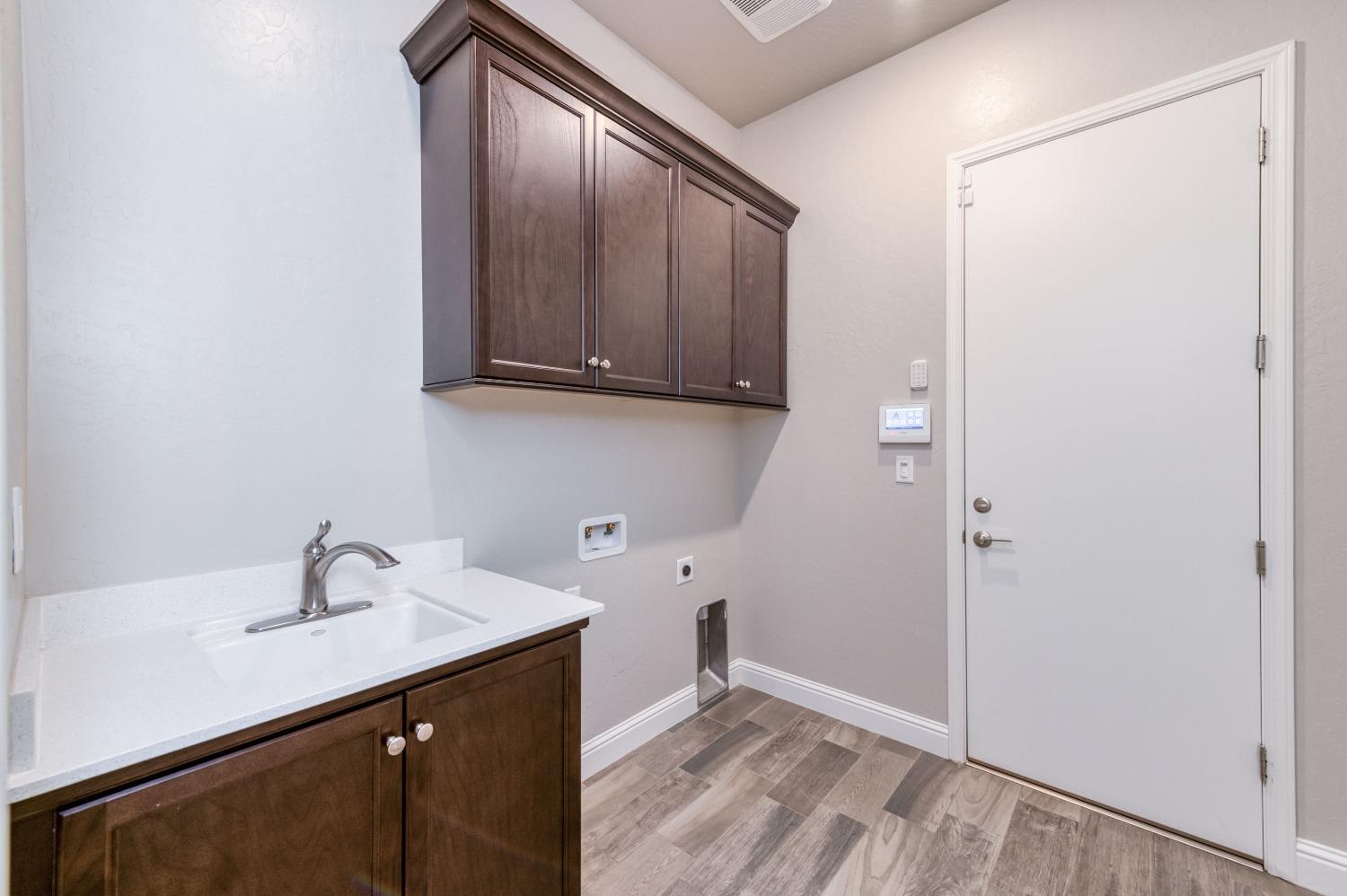 1729 North Carson Avenue Clovis, CA 93619 - Photo 17 of 38 a kitchen with a sink and a wooden floor