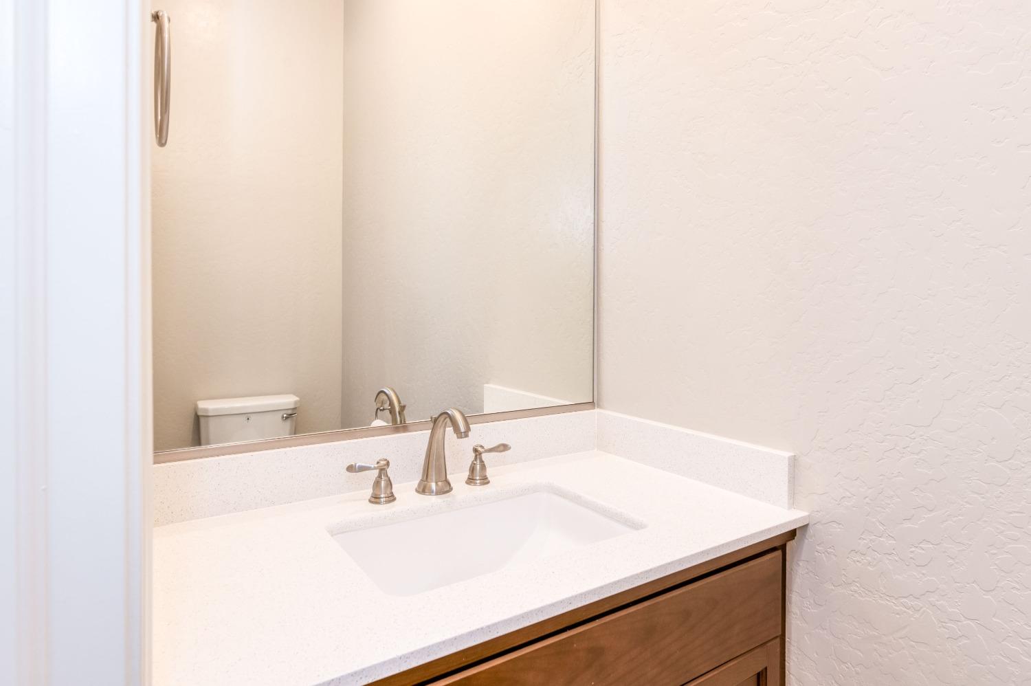 1729 North Carson Avenue Clovis, CA 93619 - Photo 18 of 38 a bathroom with a sink and a mirror