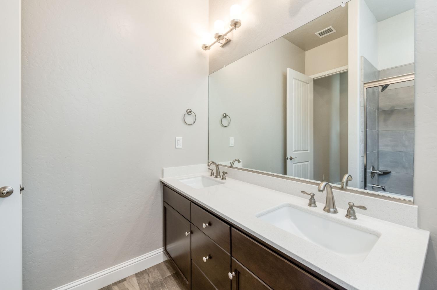 1729 North Carson Avenue Clovis, CA 93619 - Photo 20 of 38 a bathroom with a sink and a mirror