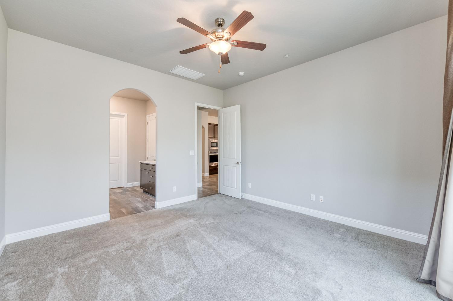 1729 North Carson Avenue Clovis, CA 93619 - Photo 25 of 38 an empty room with closet and a ceiling fan