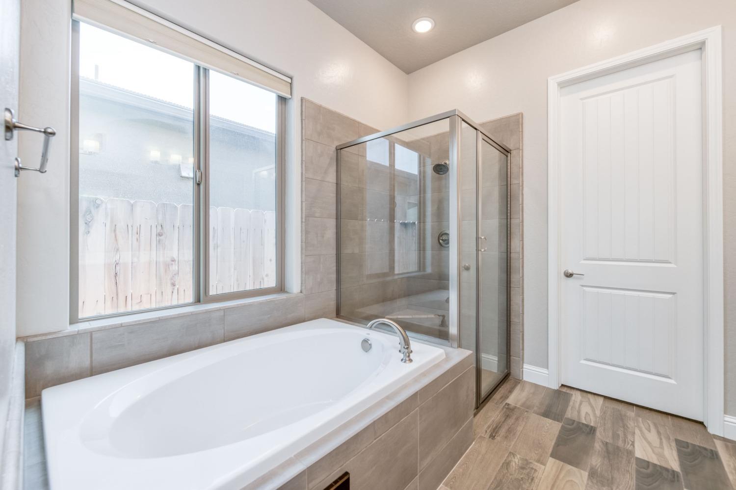 1729 North Carson Avenue Clovis, CA 93619 - Photo 26 of 38 a bathroom with a bathtub and a shower