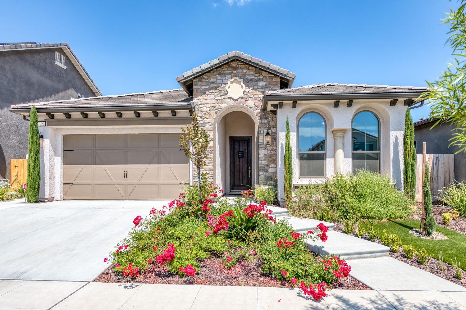 1729 North Carson Avenue Clovis, CA 93619 - Photo 33 of 38 a front view of a house with a lot of flowers