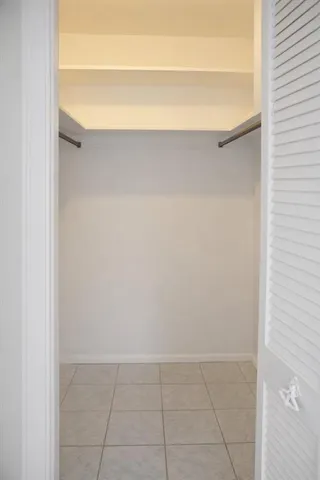 a view of walk in closet with a fireplace