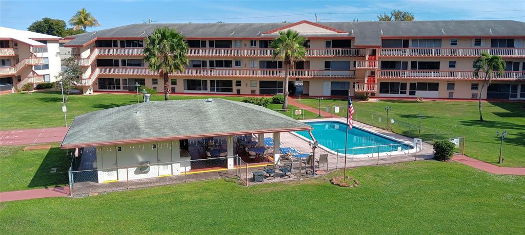5300 Washington Street, Unit 107D Hollywood, FL 33021 - Photo 19 of 23 a view of a house with a yard table and chairs