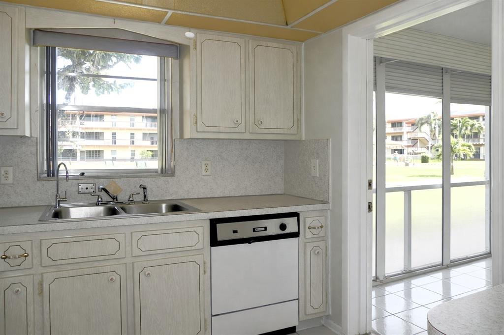 5300 Washington Street, Unit 107D Hollywood, FL 33021 - Photo 4 of 23 a kitchen with white cabinets and a window
