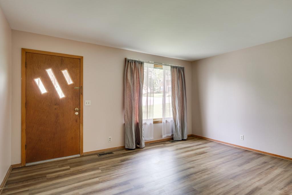 851 Reeves Road Antioch, TN 37013 - Photo 5 of 25 an empty room with wooden floor and windows