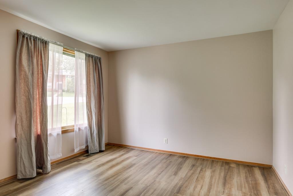 851 Reeves Road Antioch, TN 37013 - Photo 6 of 25 an empty room with wooden floor and windows