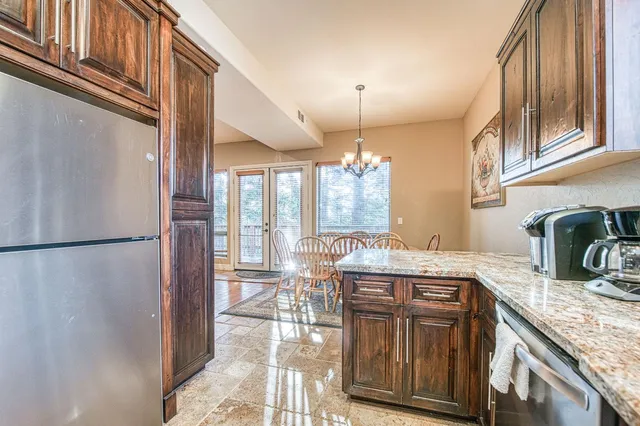a bathroom with a granite countertop sink a toilet and a mirror