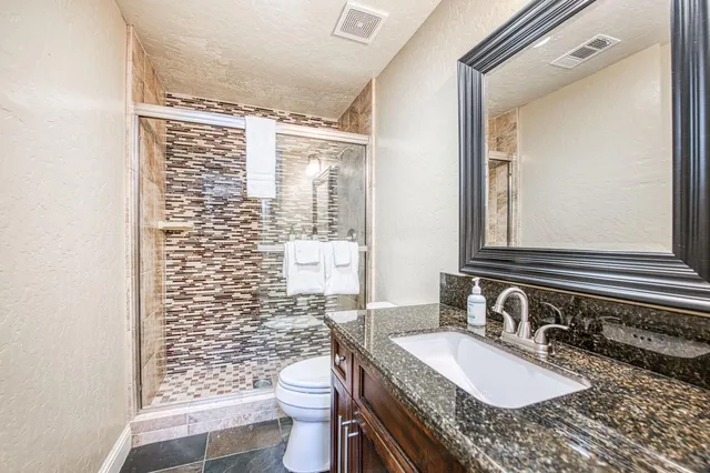 a balcony with wooden floor and outdoor seating