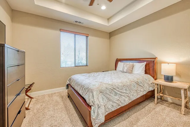 a bedroom with a bed and a night stand