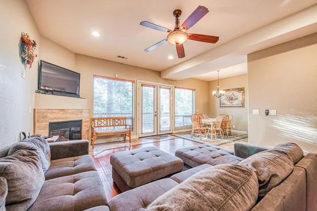 a living room with furniture a large window and a flat screen tv