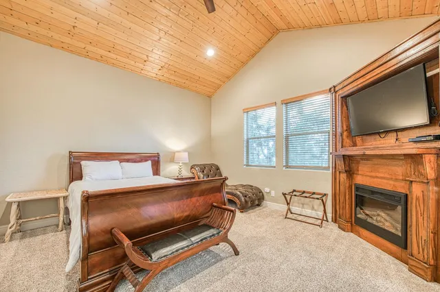 a bedroom with a bed and a fireplace