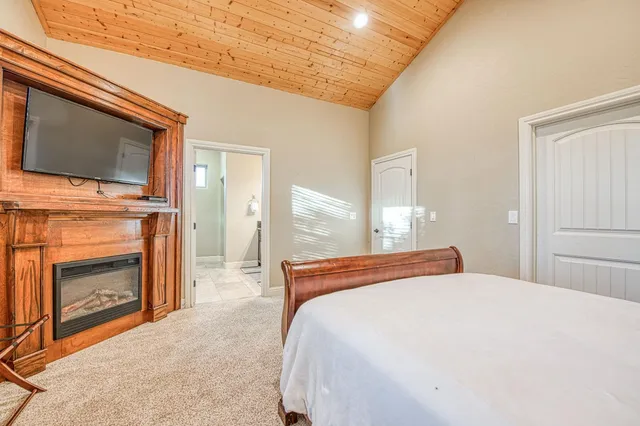 a spacious bathroom with a granite countertop sink a mirror and a shower