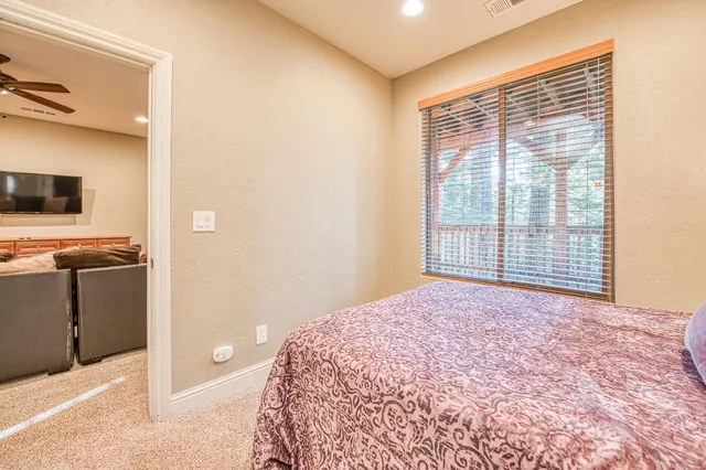 a bedroom with a bed and a baby crib