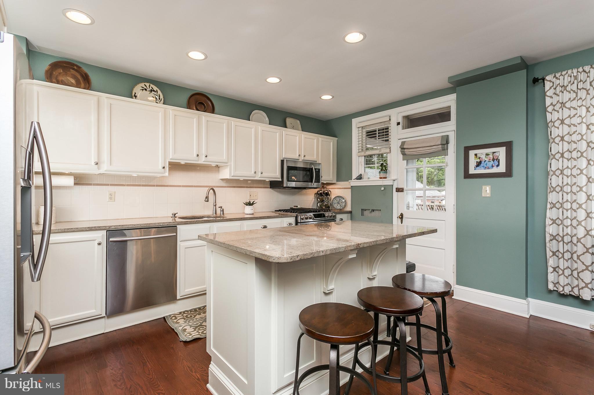 314 Dunkirk Road Baltimore, MD 21212 - Photo 11 of 28 a kitchen with kitchen island granite countertop a sink cabinets and stainless steel appliances