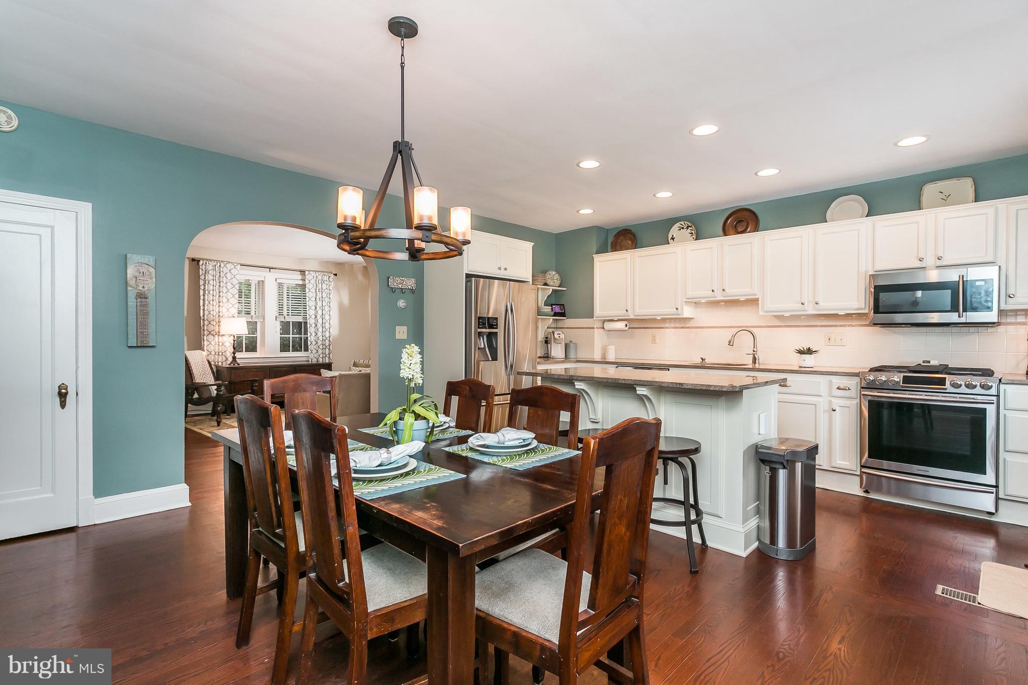 314 Dunkirk Road Baltimore, MD 21212 - Photo 12 of 28 a kitchen with stainless steel appliances a dining table chairs stove and refrigerator