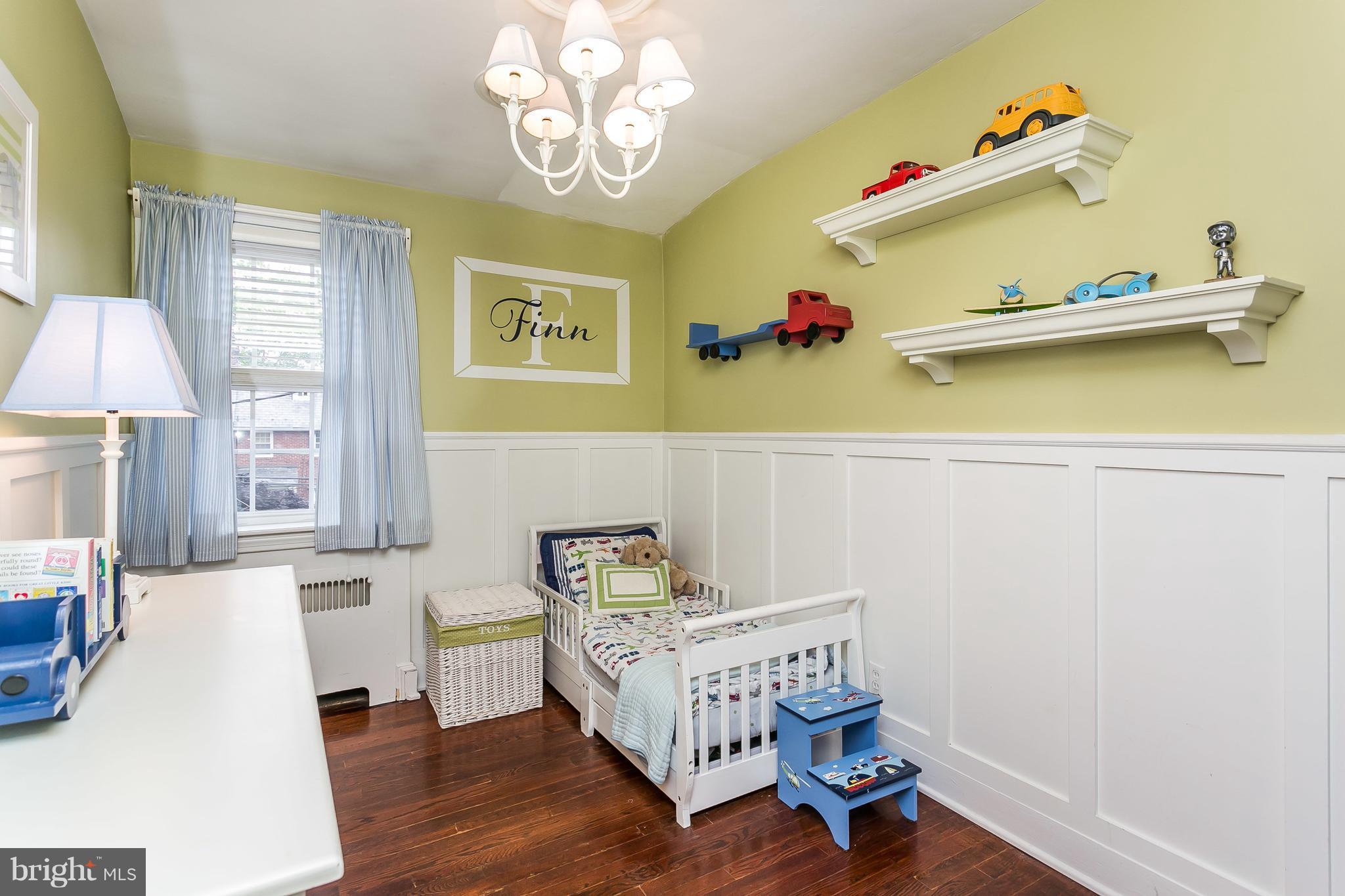 314 Dunkirk Road Baltimore, MD 21212 - Photo 16 of 28 a bedroom with a bed and wooden floor