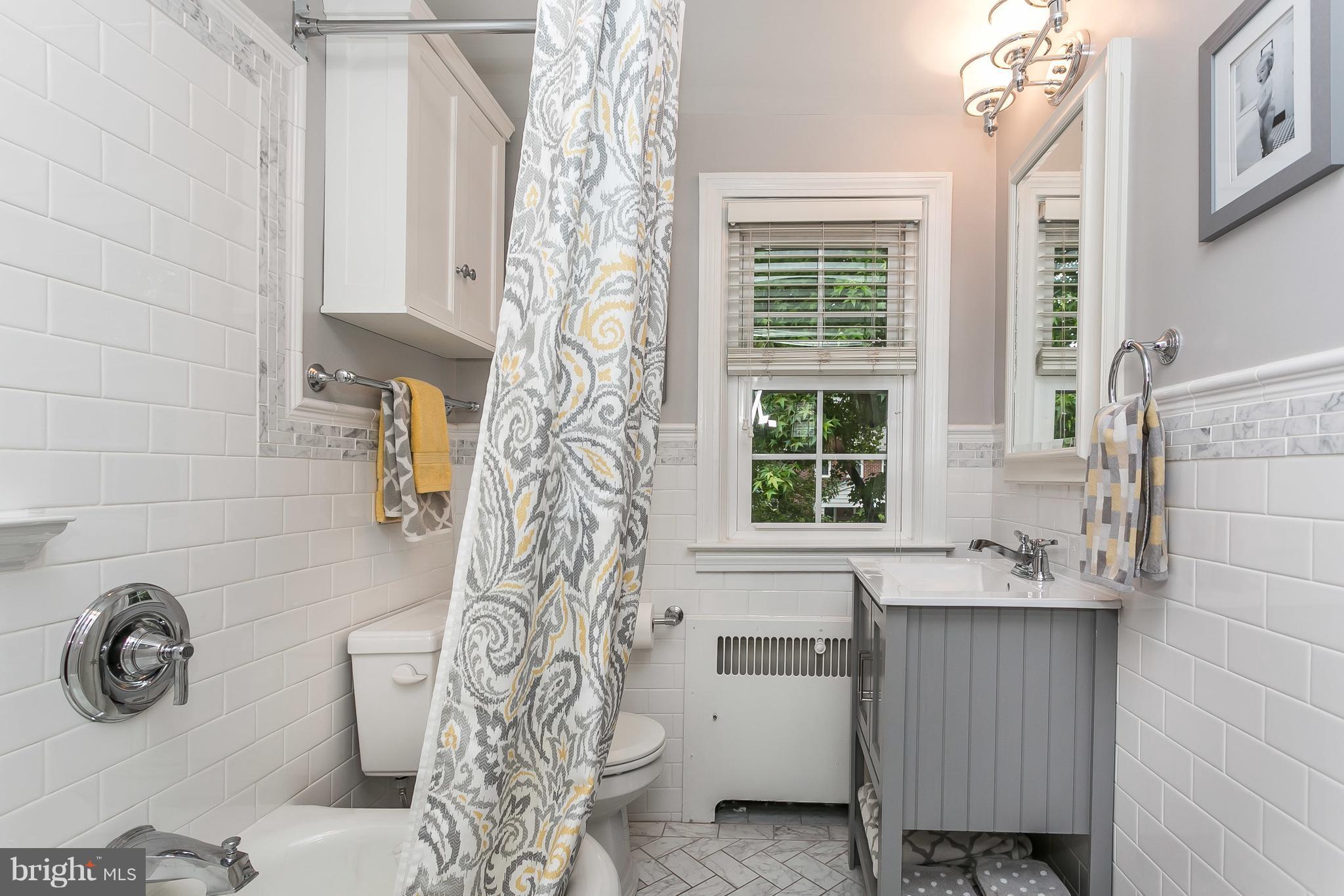 314 Dunkirk Road Baltimore, MD 21212 - Photo 17 of 28 a bathroom with a granite countertop sink and a window