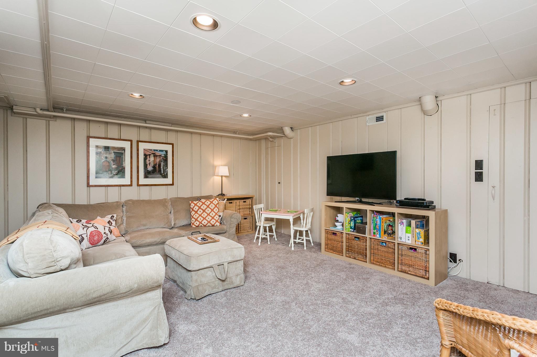 314 Dunkirk Road Baltimore, MD 21212 - Photo 23 of 28 a living room with furniture and a flat screen tv