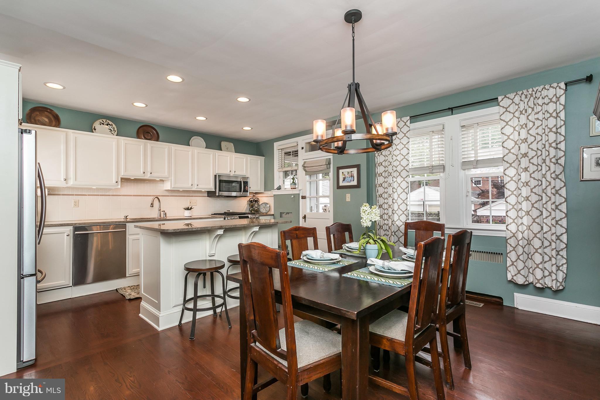 314 Dunkirk Road Baltimore, MD 21212 - Photo 5 of 28 a view of a dining room and livingroom with furniture wooden floor a chandelier