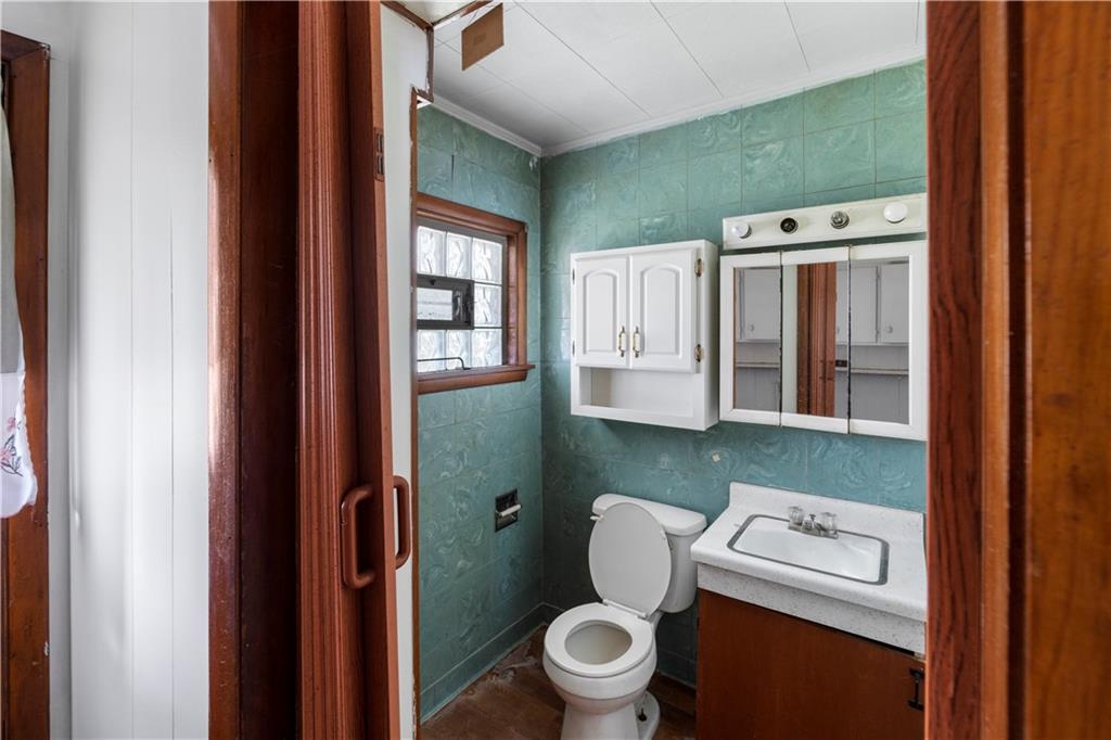 311 East Lutton Street New Castle, PA 16101 - Photo 4 of 10 a bathroom with a toilet sink and mirror