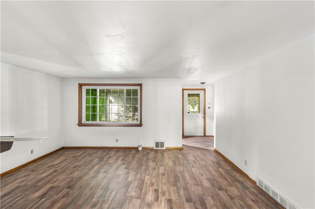311 East Lutton Street New Castle, PA 16101 - Photo 6 of 10 an empty room with wooden floor and windows