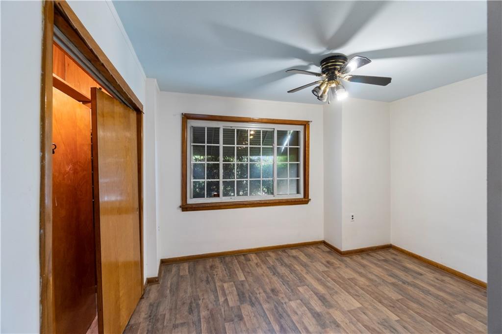 311 East Lutton Street New Castle, PA 16101 - Photo 9 of 10 an empty room with wooden floor chandelier fan and windows