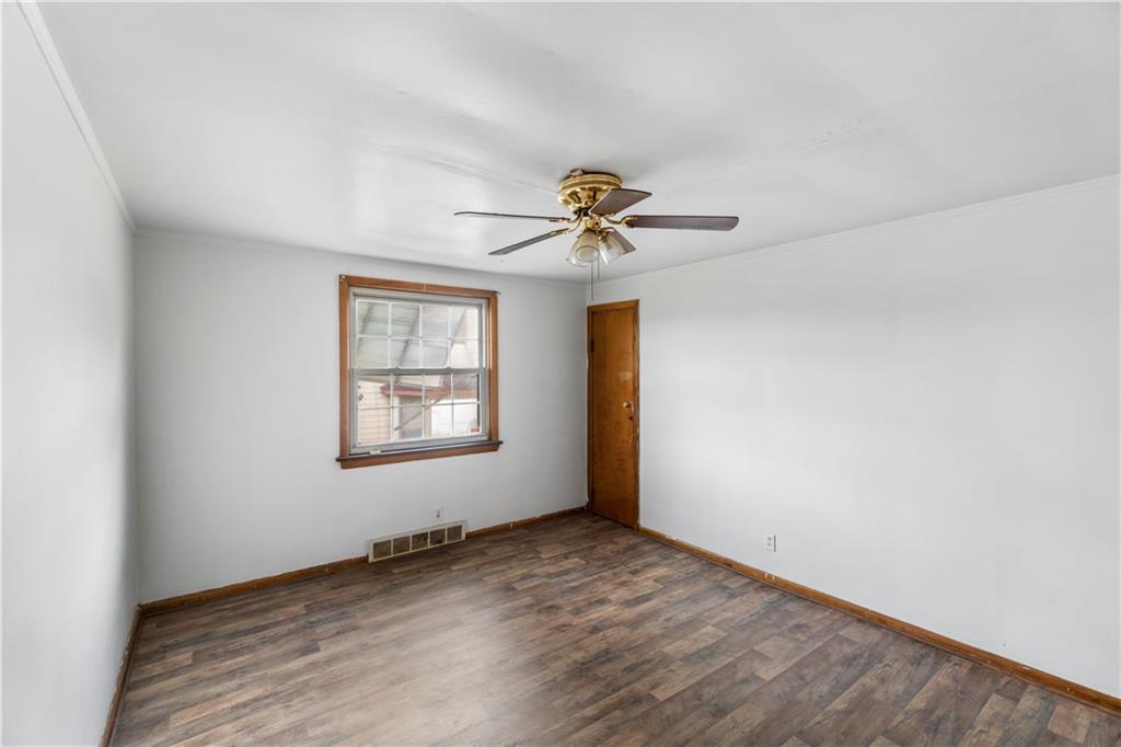 311 East Lutton Street New Castle, PA 16101 - Photo 10 of 10 an empty room with a window and a ceiling fan